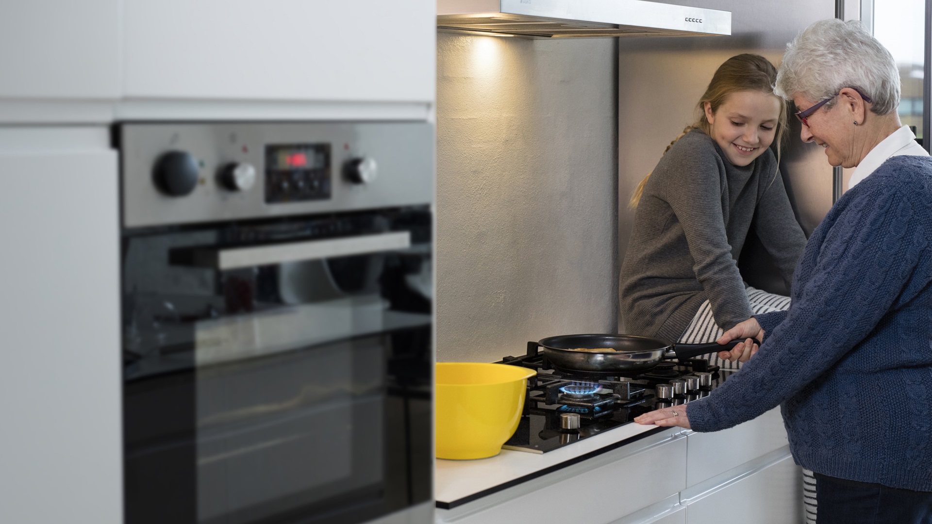 Girl and grandmother in kitchen, Gas segment